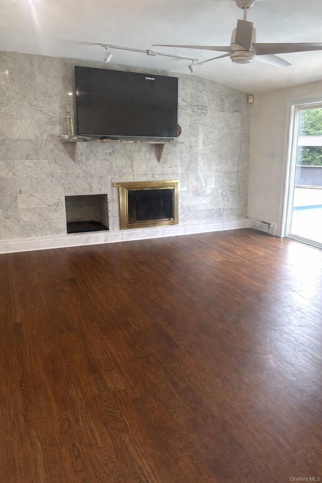 4 Halliday Road Coram, NY 11727 - Photo 14 of 19 a view of empty room with a fireplace and wooden floor