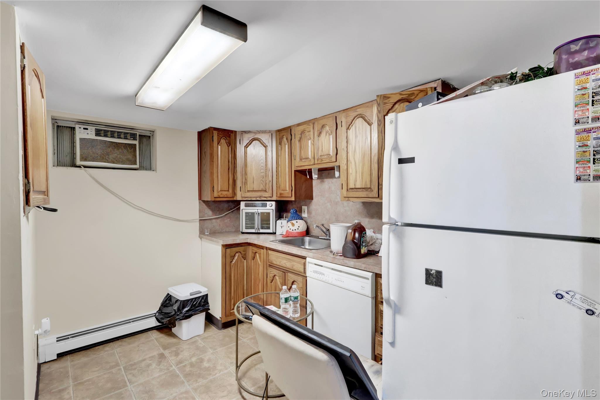 4 Halliday Road Coram, NY 11727 - Photo 21 of 28 a kitchen with a refrigerator a sink and cabinets