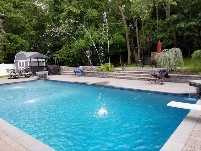 4 Halliday Road Coram, NY 11727 - Photo 23 of 28 a view of a swimming pool with a patio and a yard