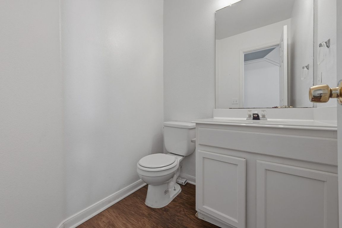 5237 Coppermead Lane Austin, TX 78754 - Photo 11 of 25 a bathroom with a toilet sink and mirror