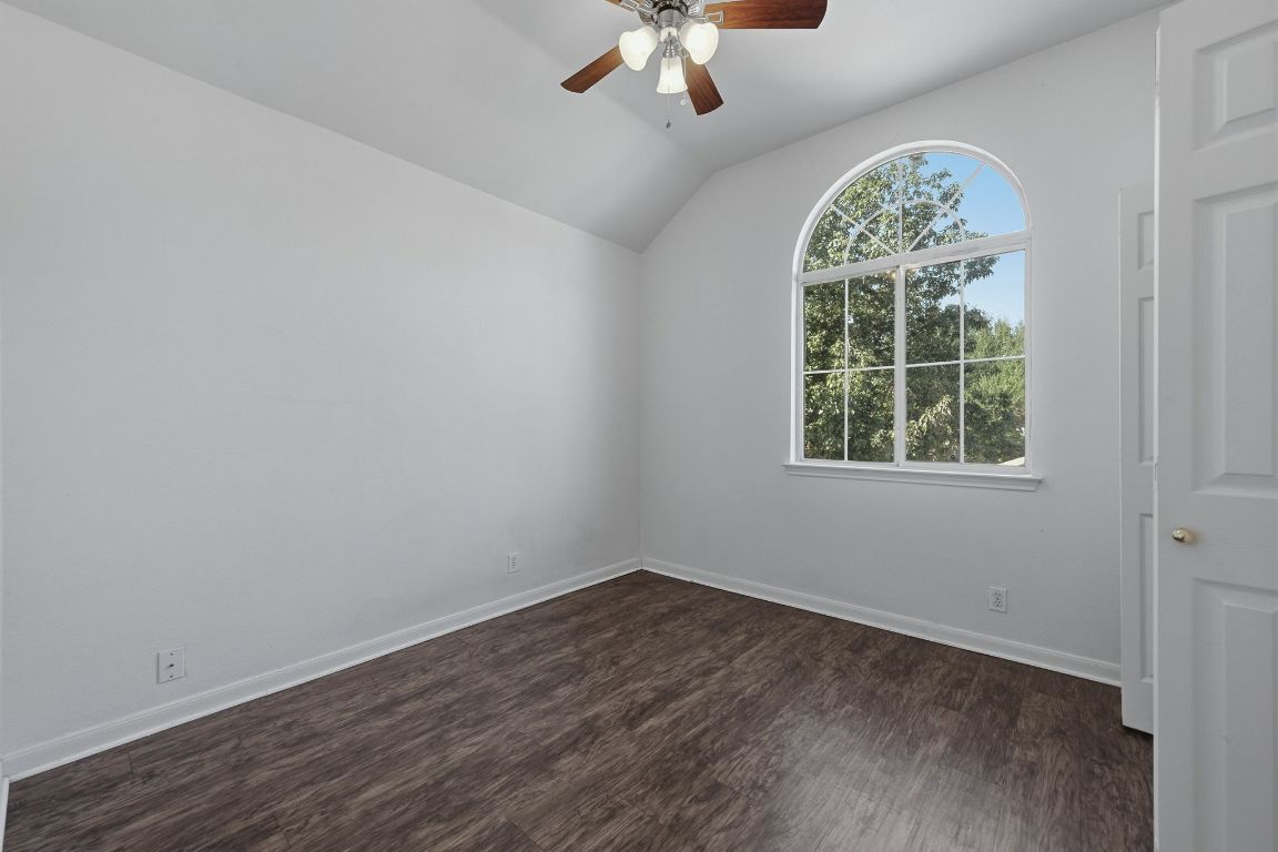 5237 Coppermead Lane Austin, TX 78754 - Photo 17 of 25 an empty room with wooden floor chandelier and windows