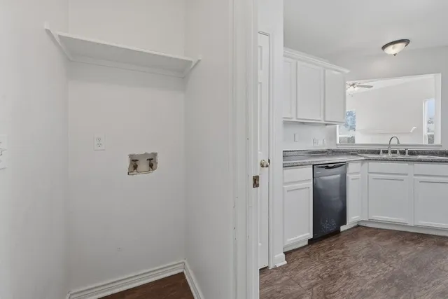 a kitchen with a sink cabinets and appliances