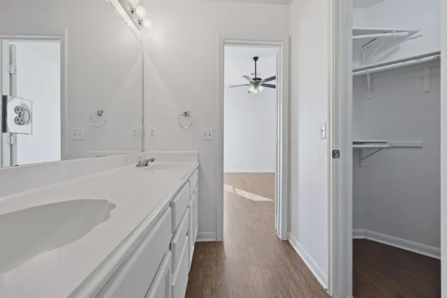 a bathroom with a tub shower vanity and a sink