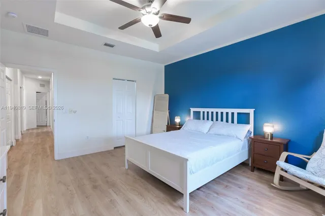 a bedroom with a bed and a chandelier