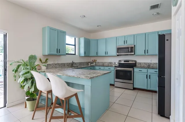 a kitchen with kitchen island granite countertop counter top space appliances and a center island