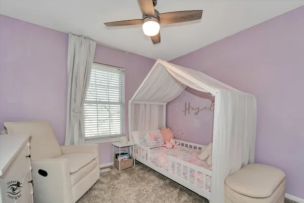 a spacious bedroom with a bed and a window