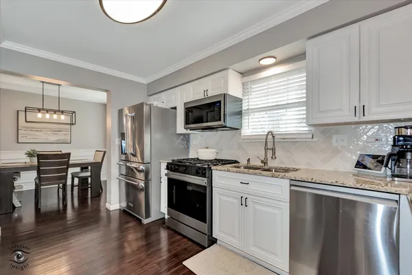 a kitchen with a stove a sink and a refrigerator