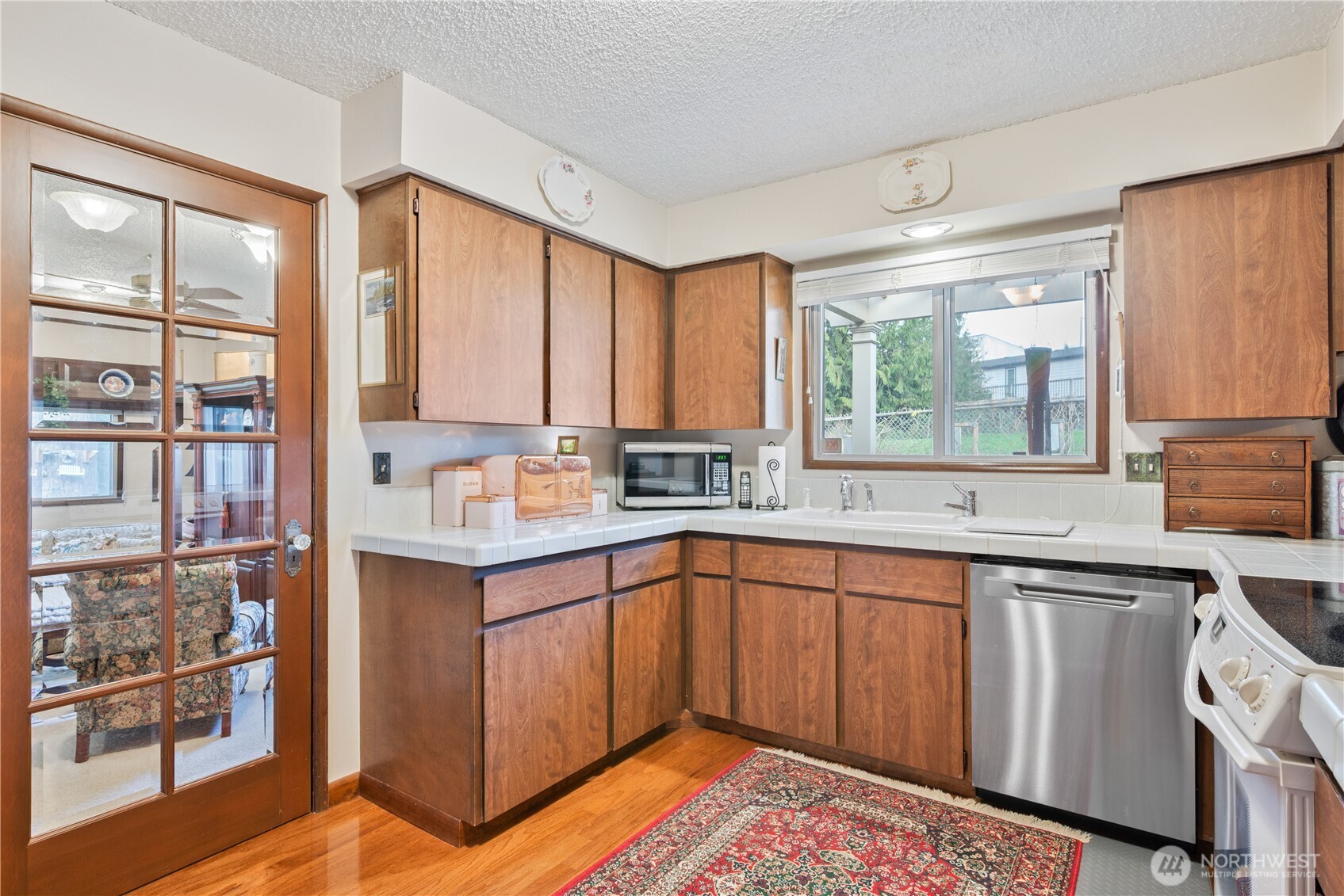 1008 16th Place Kelso, WA 98626 - Photo 13 of 40 a kitchen with stainless steel appliances granite countertop a sink and cabinets