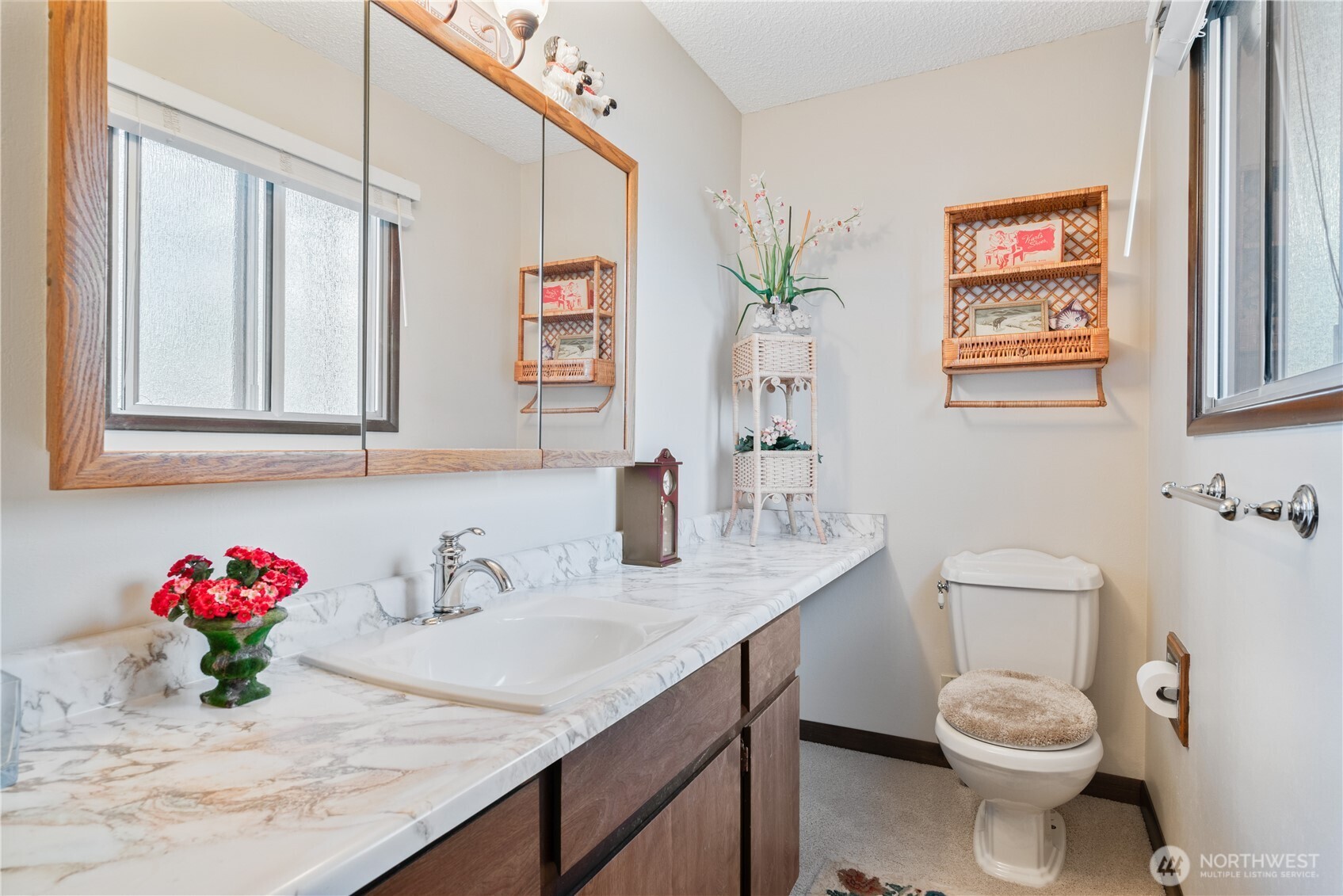 1008 16th Place Kelso, WA 98626 - Photo 23 of 40 a bathroom with a granite countertop sink a toilet and a shower