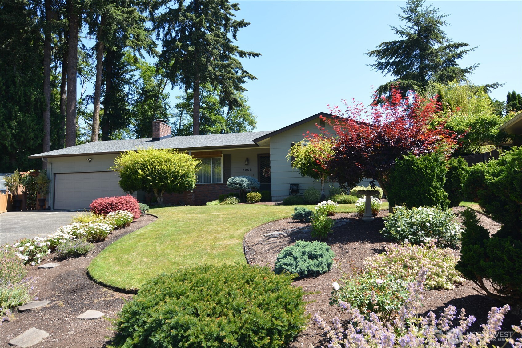 1008 16th Place Kelso, WA 98626 - Photo 34 of 40 a front view of a house with a yard and a garden
