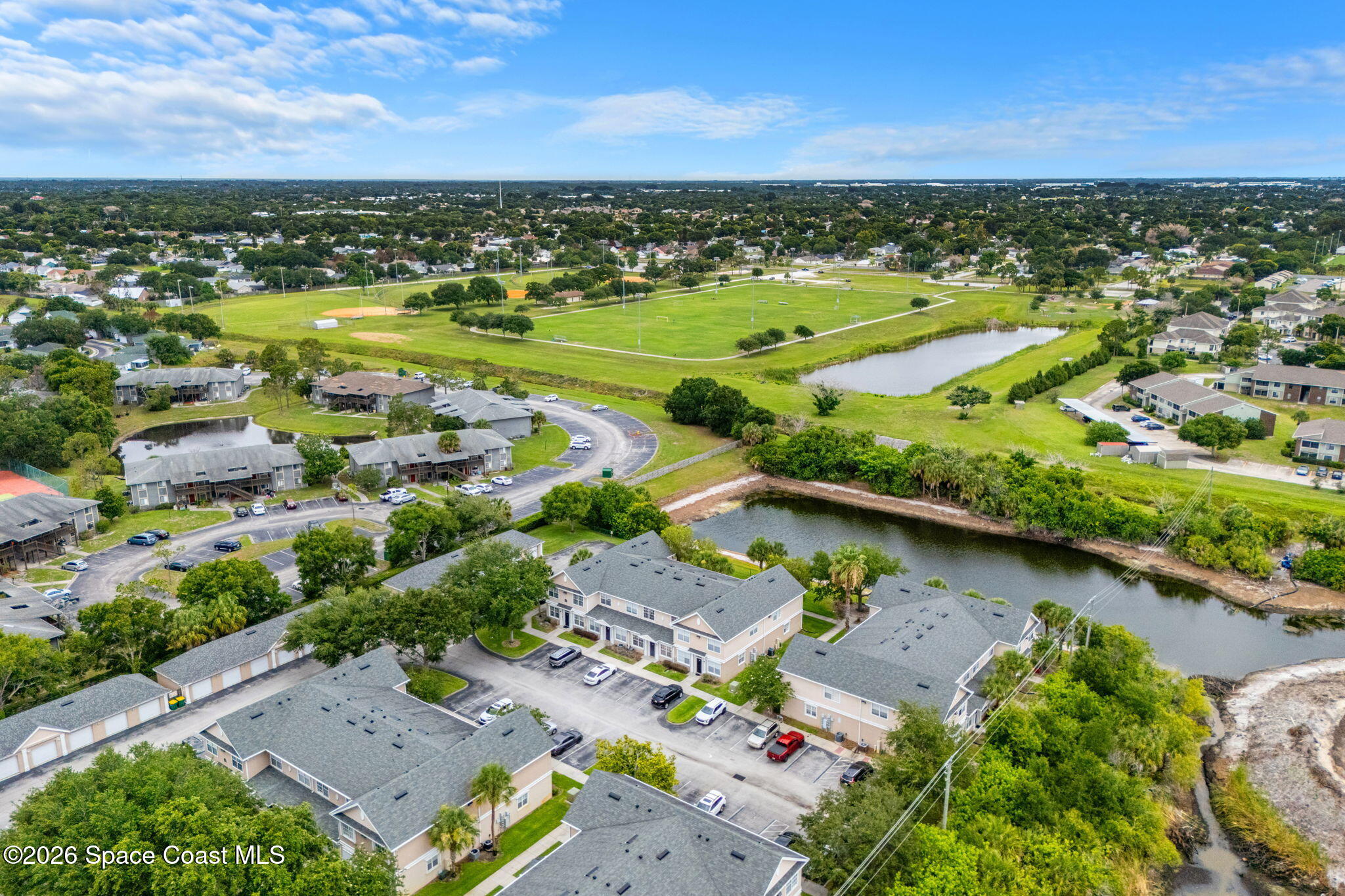 110 Turpial Way, Unit 106 Melbourne, FL 32901 - Photo 50 of 50 an aerial view of residential houses with outdoor space