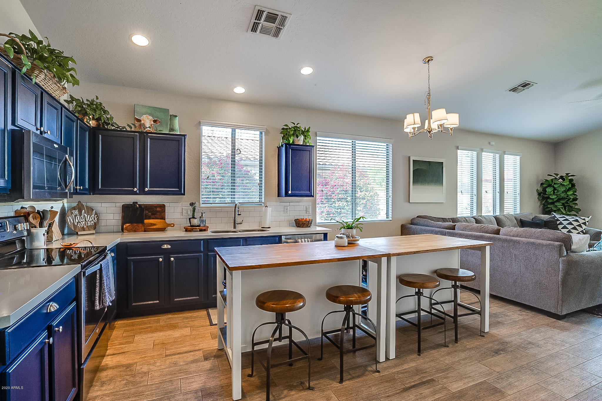 2520 East Fremont Road Phoenix, AZ 85042 - Photo 13 of 62 a kitchen with lots of counter top space cabinets dining table and stainless steel appliances