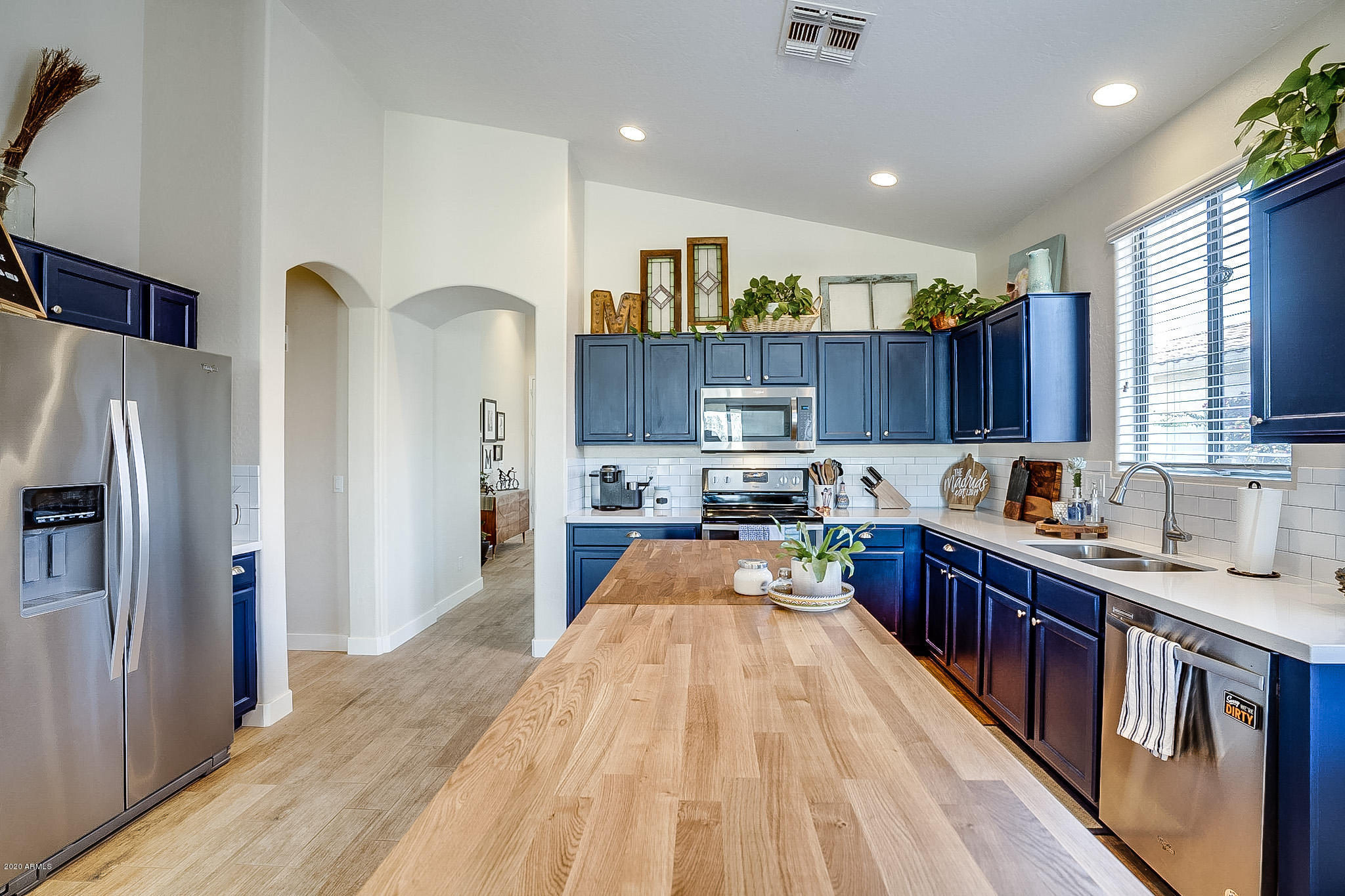 2520 East Fremont Road Phoenix, AZ 85042 - Photo 16 of 62 a kitchen with stainless steel appliances granite countertop a refrigerator a sink dishwasher a stove and a dining table with wooden floor