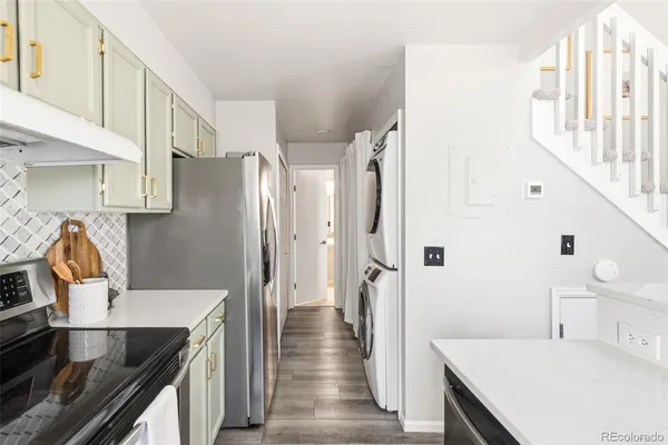 a kitchen with stainless steel appliances a refrigerator and a stove
