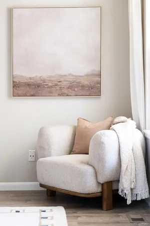 a living room with furniture and a mirror