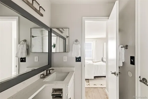 a bathroom with a tub sink and mirror