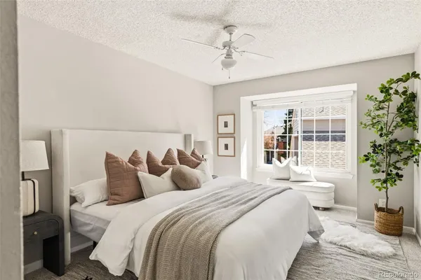 a bedroom with a large bed and a potted plant