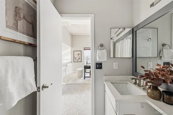 a bathroom with a tub sink and mirror