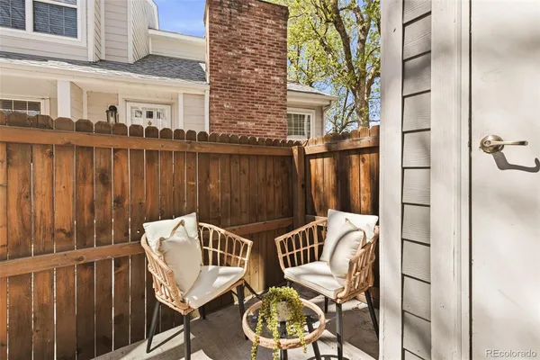 a view of a patio with two chairs and a table