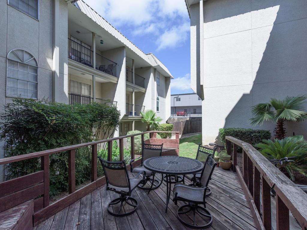 910 Duncan Lane, Unit 2 Austin, TX 78705 - Photo 11 of 11 An inviting deck area offers space for outdoor living amidst manicured landscaping.