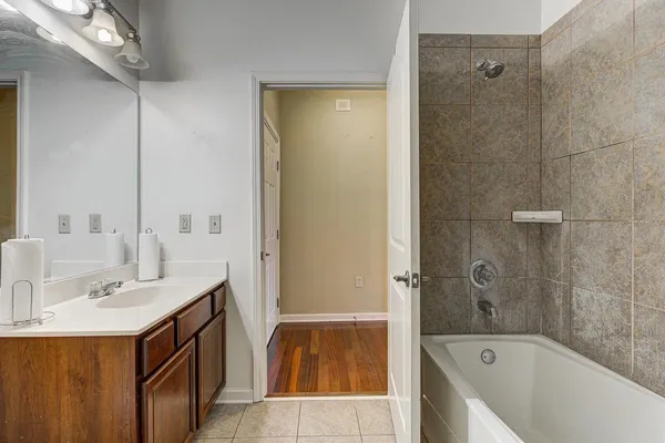 a bathroom with a sink a mirror bathtub and shower