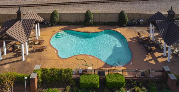 an aerial view of a house swimming pool patio and outdoor seating