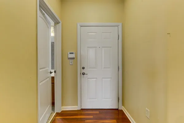 a view of front door with wooden floor