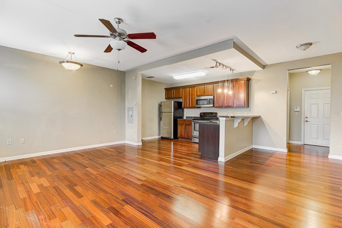 731 Litty Court, Unit 105 Memphis, TN 38103 - Photo 7 of 15 a view of kitchen with refrigerator microwave and stove top oven