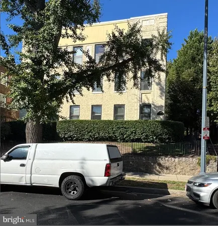 a view of a white house with a yard