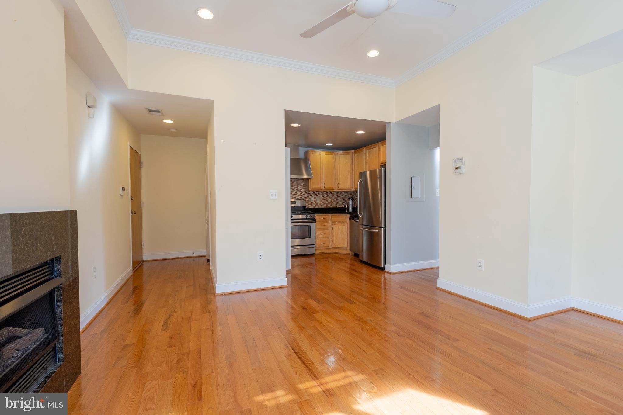 1437 Spring Road Northwest, Unit 32 Washington, DC 20010 - Photo 9 of 13 a view of a kitchen with wooden floor and a refrigerator