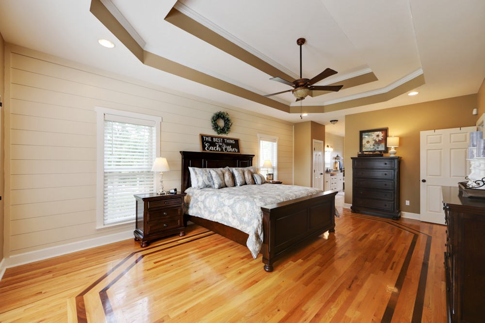 758 Sugar Flat Road Lebanon, TN 37087 - Photo 11 of 44 a spacious bedroom with a bed and a chandelier