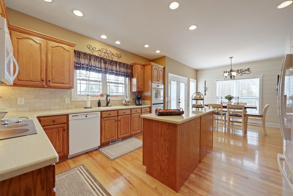758 Sugar Flat Road Lebanon, TN 37087 - Photo 15 of 44 a kitchen with stainless steel appliances granite countertop wooden cabinets a sink a stove a dining table and chairs