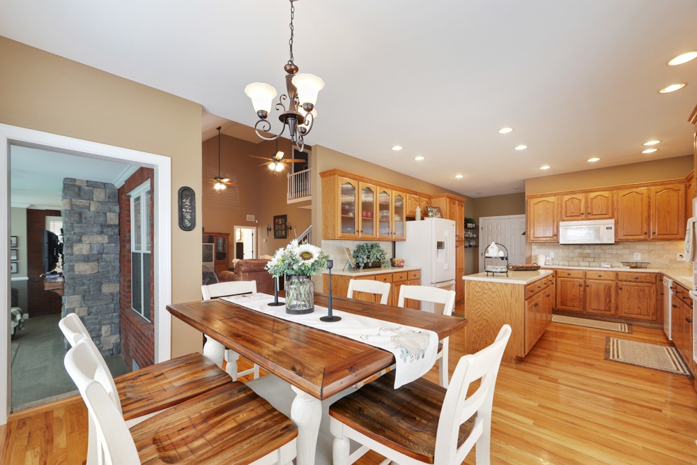 758 Sugar Flat Road Lebanon, TN 37087 - Photo 18 of 44 a dining room with wooden floor a chandelier a wooden table and chairs