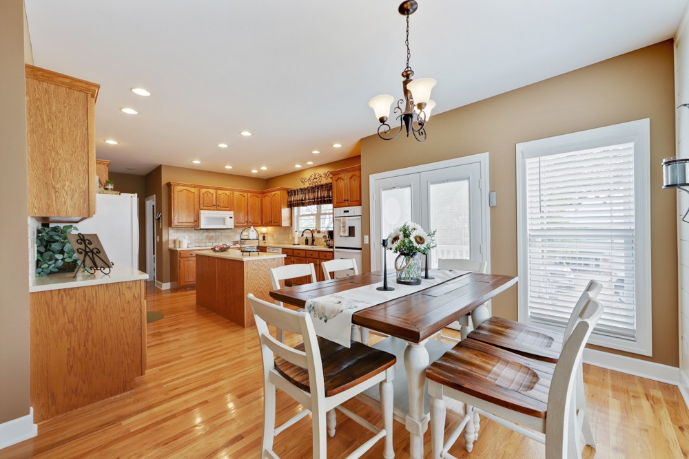 758 Sugar Flat Road Lebanon, TN 37087 - Photo 19 of 44 a view of a dining room with furniture wooden floor and a chandelier