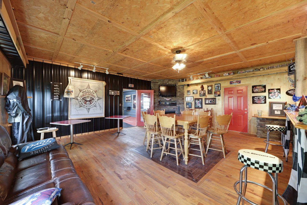 758 Sugar Flat Road Lebanon, TN 37087 - Photo 33 of 44 a dining room with furniture a rug and wooden floor