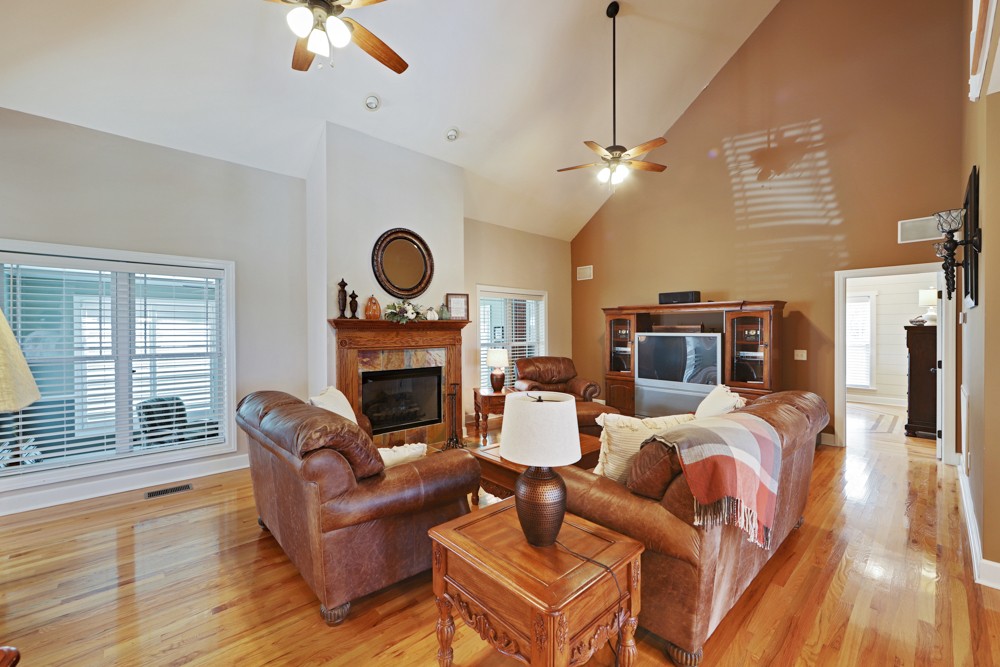 758 Sugar Flat Road Lebanon, TN 37087 - Photo 8 of 44 a living room with furniture a fireplace and a chandelier