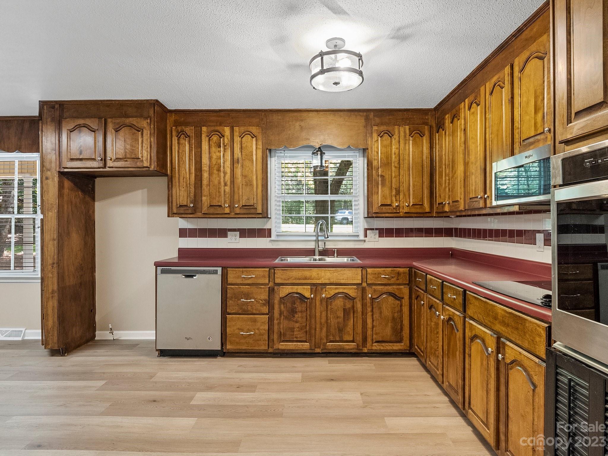 807 Red Cedar Lane Monroe, NC 28110 - Photo 15 of 34 a kitchen with stainless steel appliances granite countertop a stove a sink and a microwave