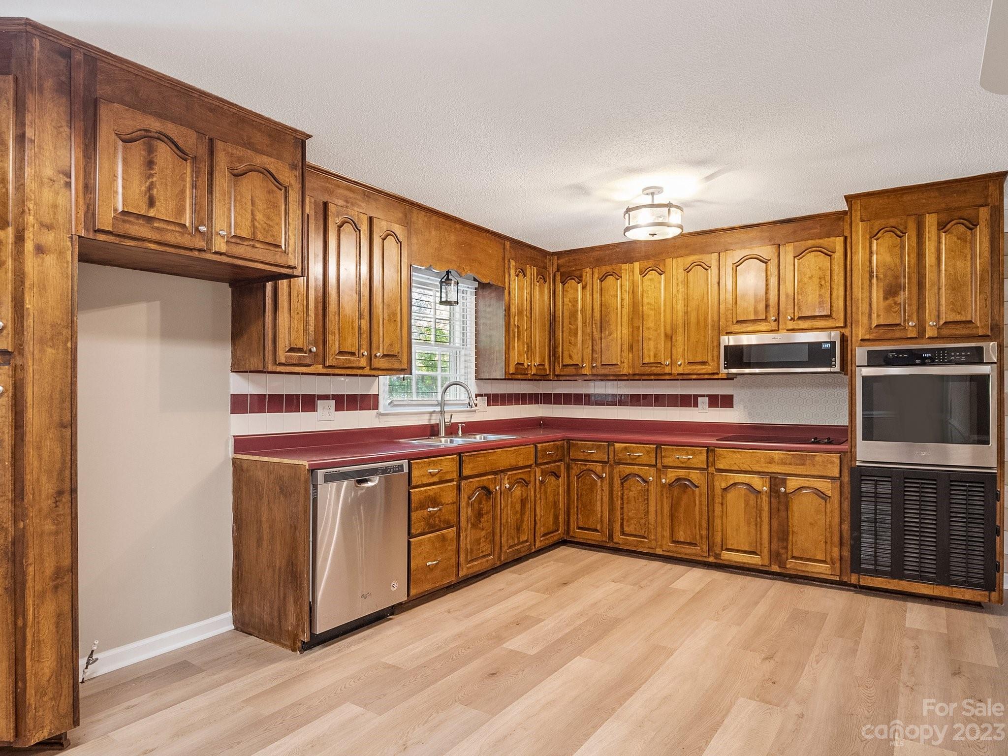807 Red Cedar Lane Monroe, NC 28110 - Photo 17 of 34 a kitchen with stainless steel appliances granite countertop a sink and cabinets