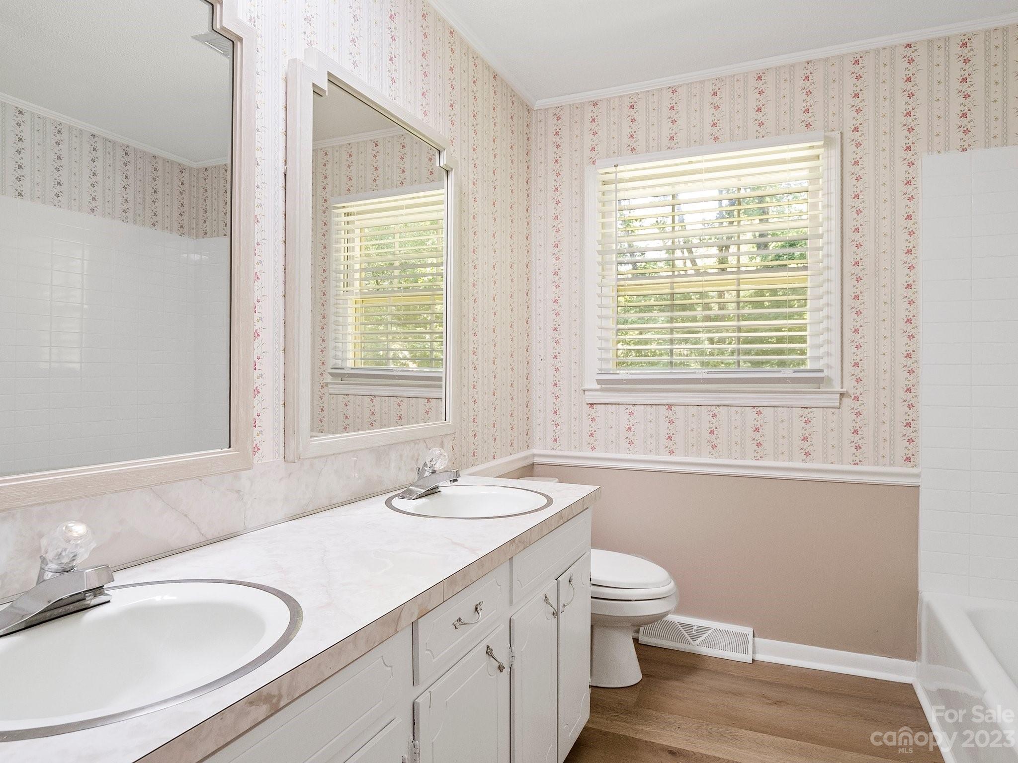 807 Red Cedar Lane Monroe, NC 28110 - Photo 20 of 34 a bathroom with a granite countertop sink toilet a large mirror and a window