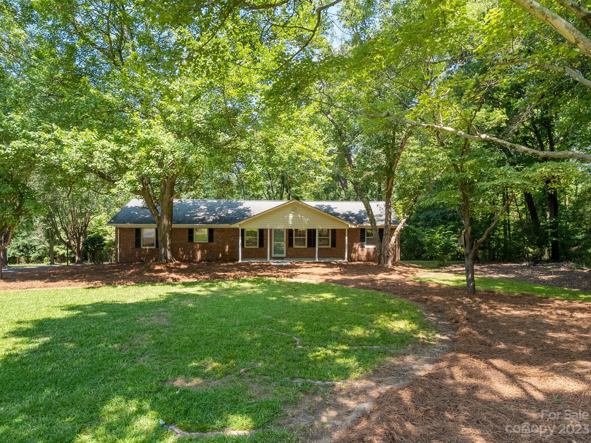 807 Red Cedar Lane Monroe, NC 28110 - Photo 2 of 34 a big yard with large trees and a small yard