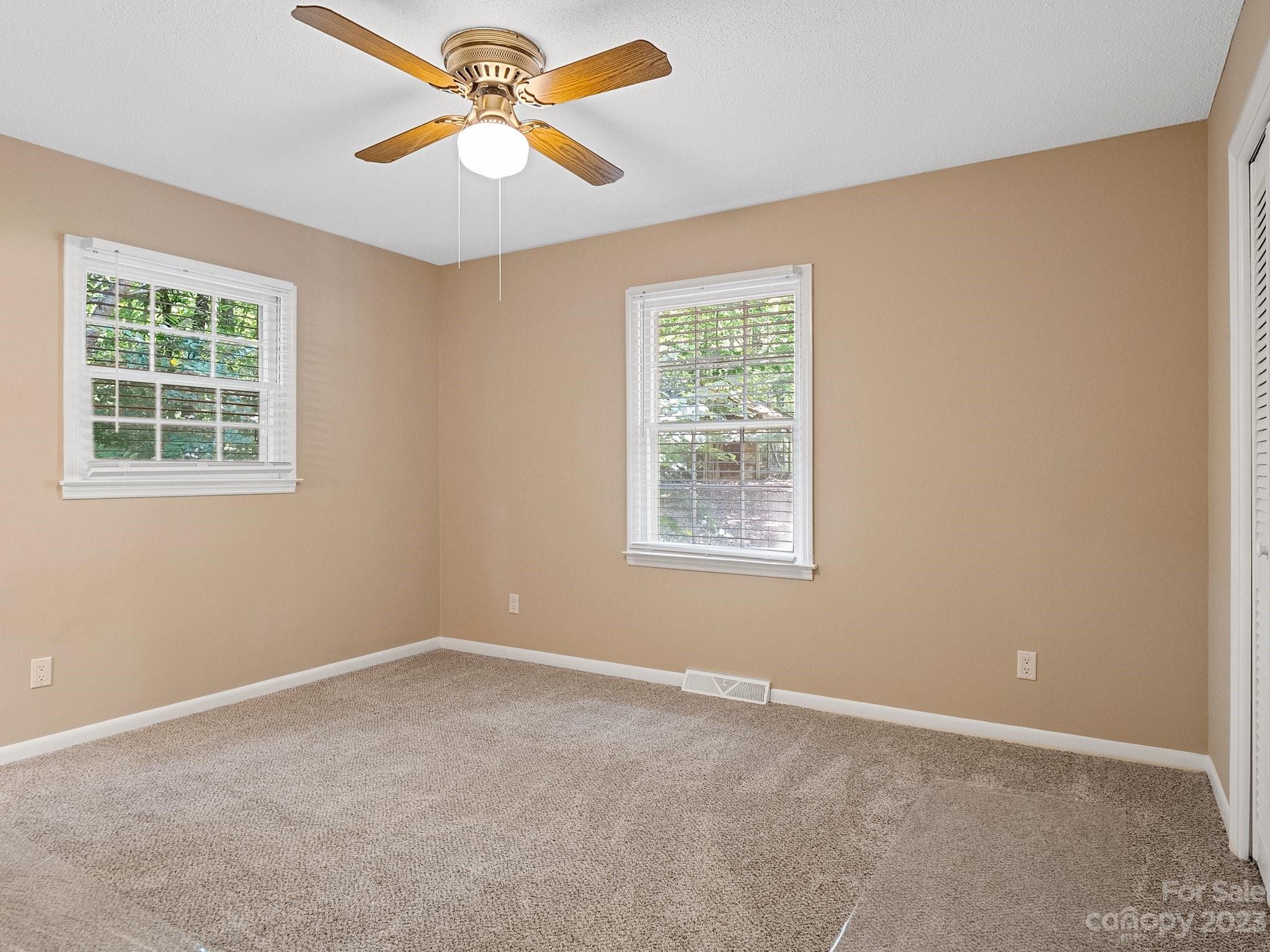 807 Red Cedar Lane Monroe, NC 28110 - Photo 23 of 34 an empty room with a window and a fan