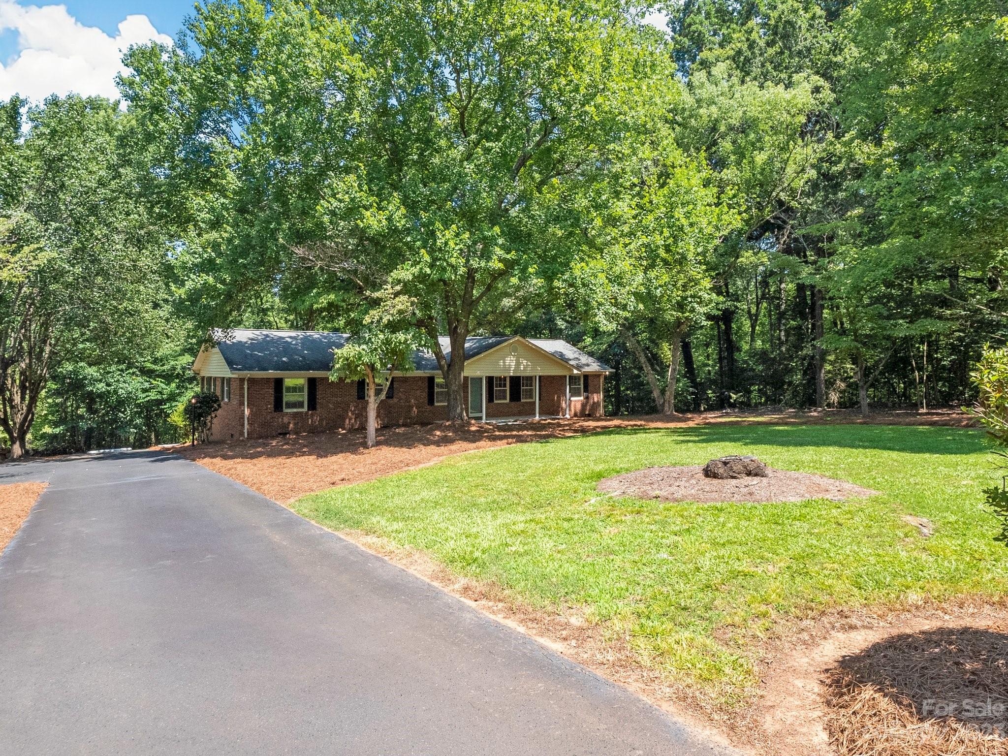 807 Red Cedar Lane Monroe, NC 28110 - Photo 3 of 34 a view of a swimming pool with a table and chairs under an umbrella