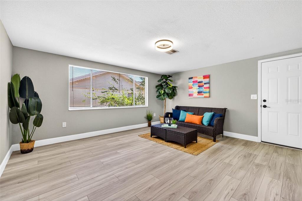 12415 Stagecoach Lane Hudson, FL 34667 - Photo 16 of 51 a living room with furniture and a wooden floor
