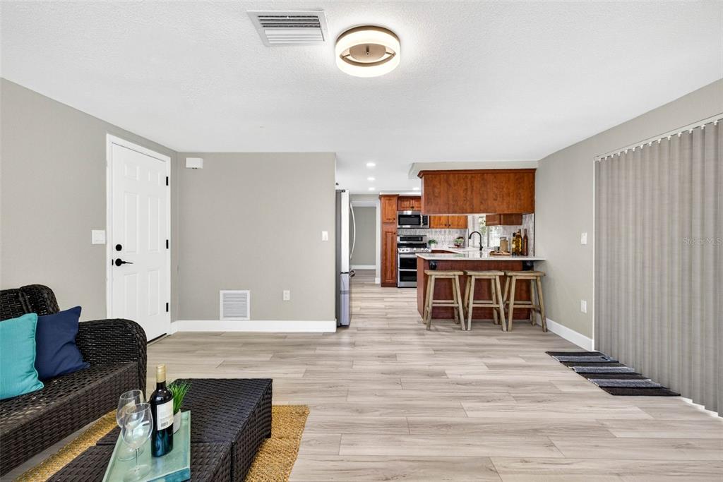 12415 Stagecoach Lane Hudson, FL 34667 - Photo 20 of 51 a living room with furniture and kitchen view