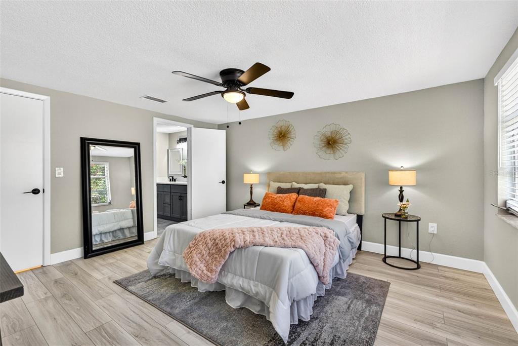 12415 Stagecoach Lane Hudson, FL 34667 - Photo 26 of 51 a bedroom with a bed and wooden floor