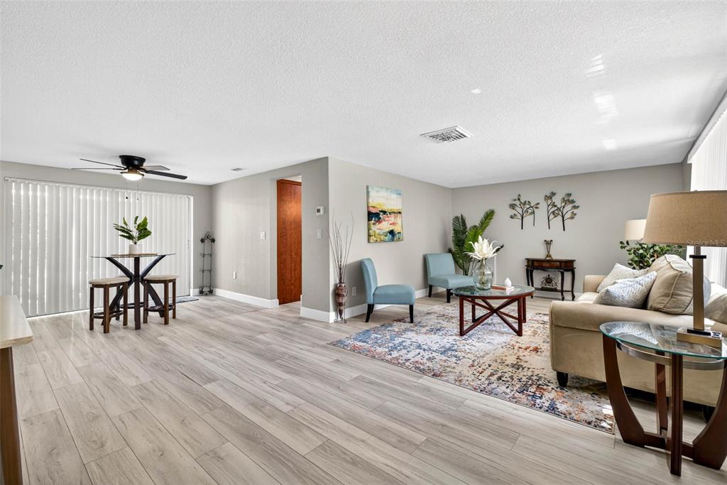 12415 Stagecoach Lane Hudson, FL 34667 - Photo 3 of 51 a living room with furniture and wooden floor