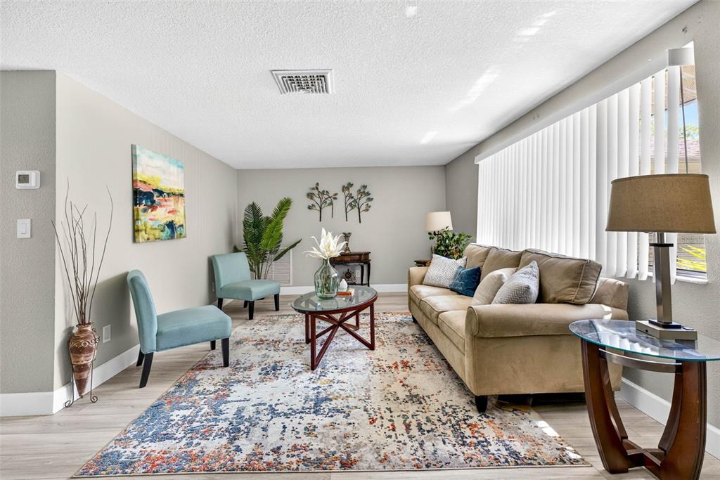 12415 Stagecoach Lane Hudson, FL 34667 - Photo 4 of 51 a living room with furniture and a rug