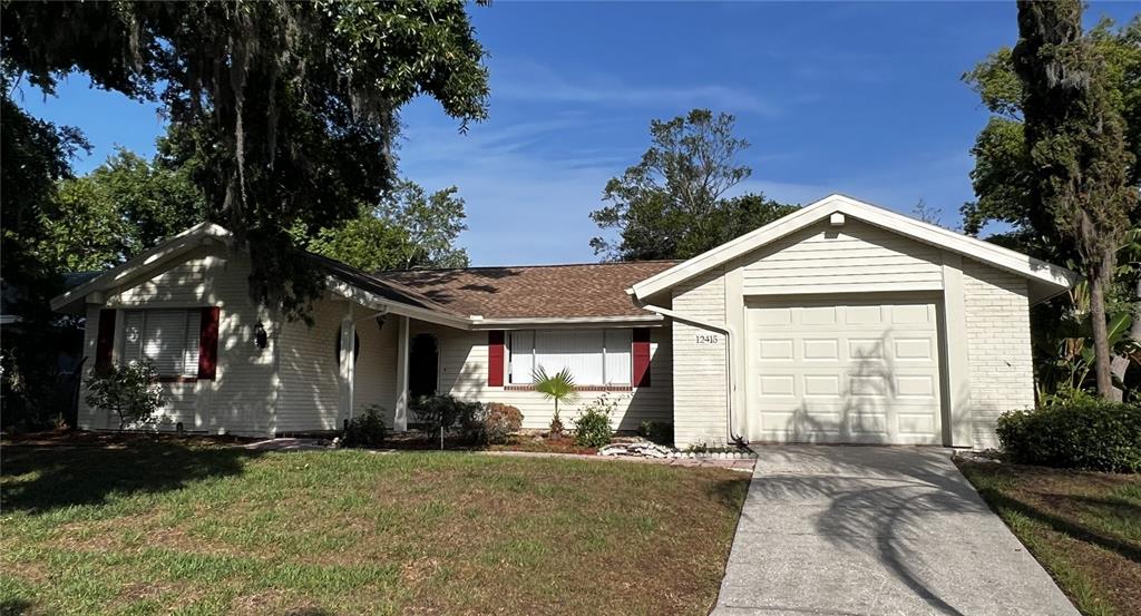12415 Stagecoach Lane Hudson, FL 34667 - Photo 51 of 51 a view of a house with a yard and tree s