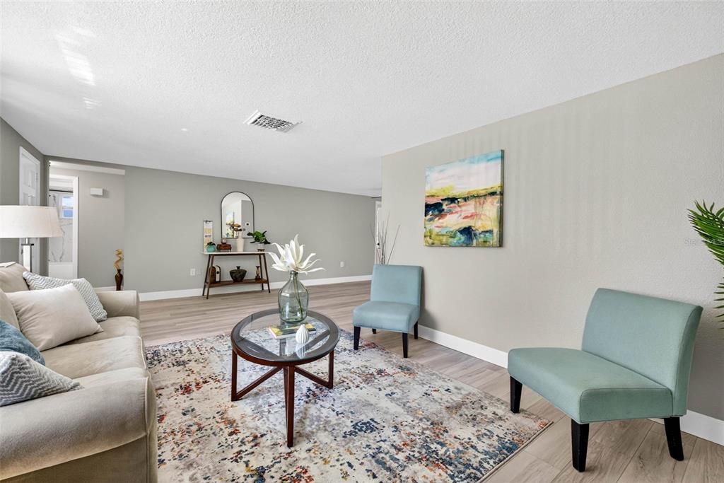 12415 Stagecoach Lane Hudson, FL 34667 - Photo 6 of 51 a living room with furniture and a rug