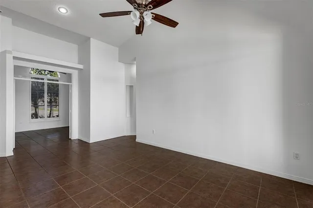 a view of kitchen with stainless steel appliances granite countertop a refrigerator and a stove
